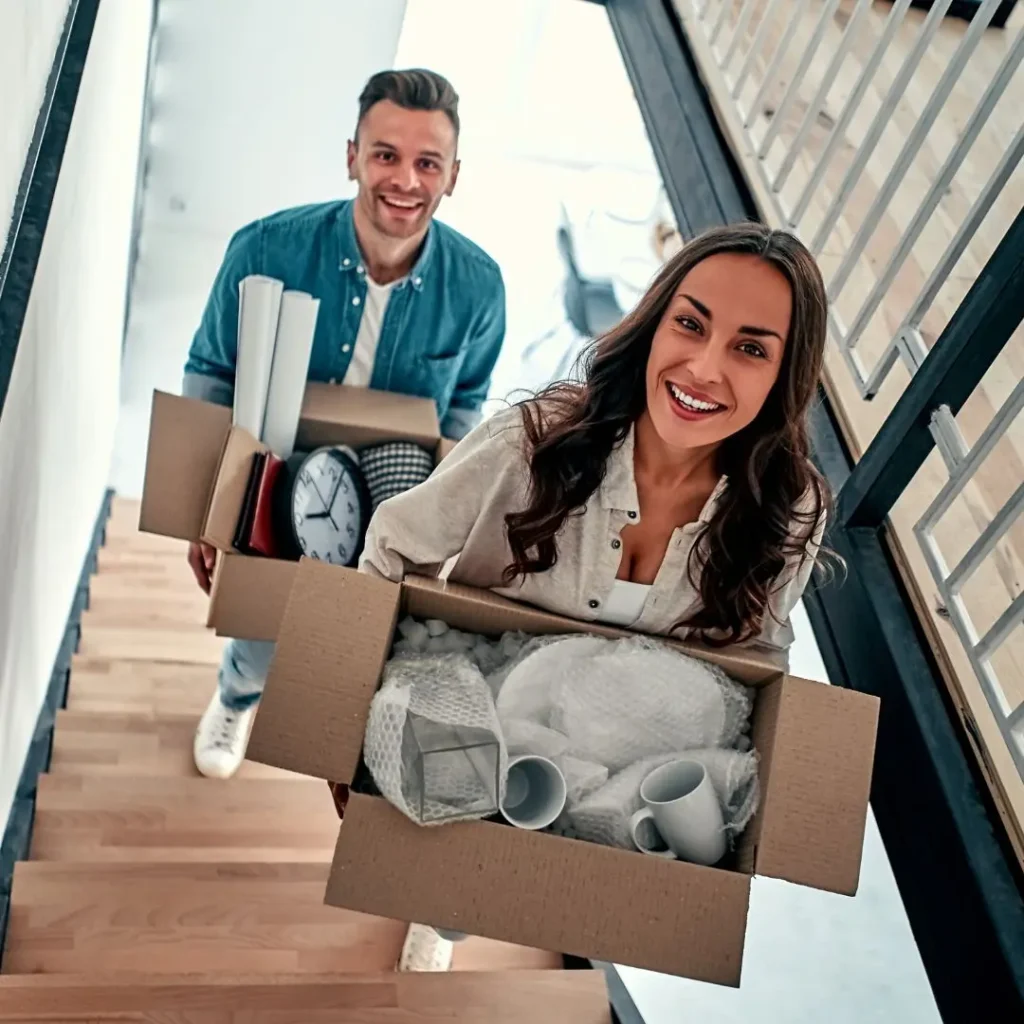 Students moving house with boxes in their hands.