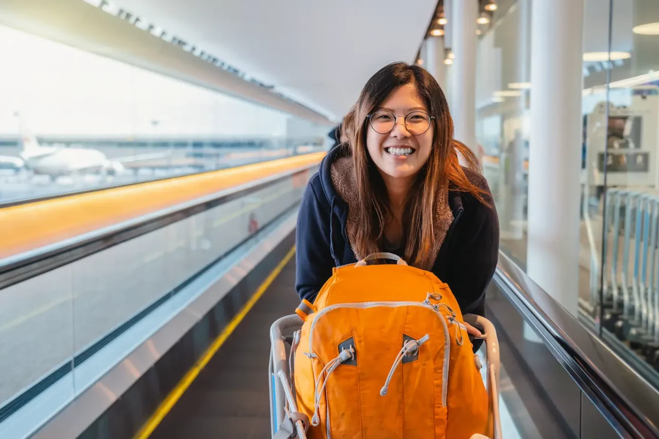 Asian student moving abroad arriving in Airport at their destination