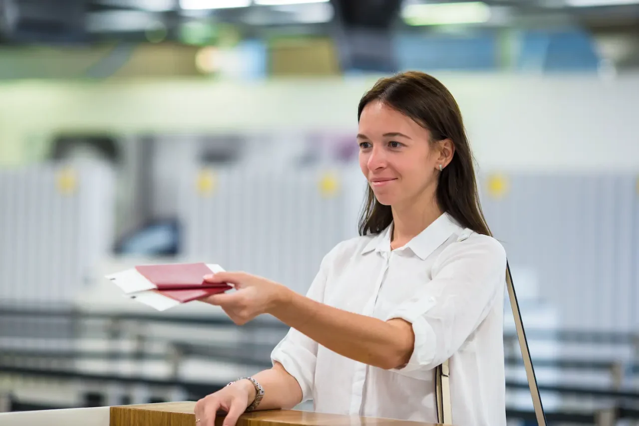 Student at the reception desk at the airport waiting for boarding